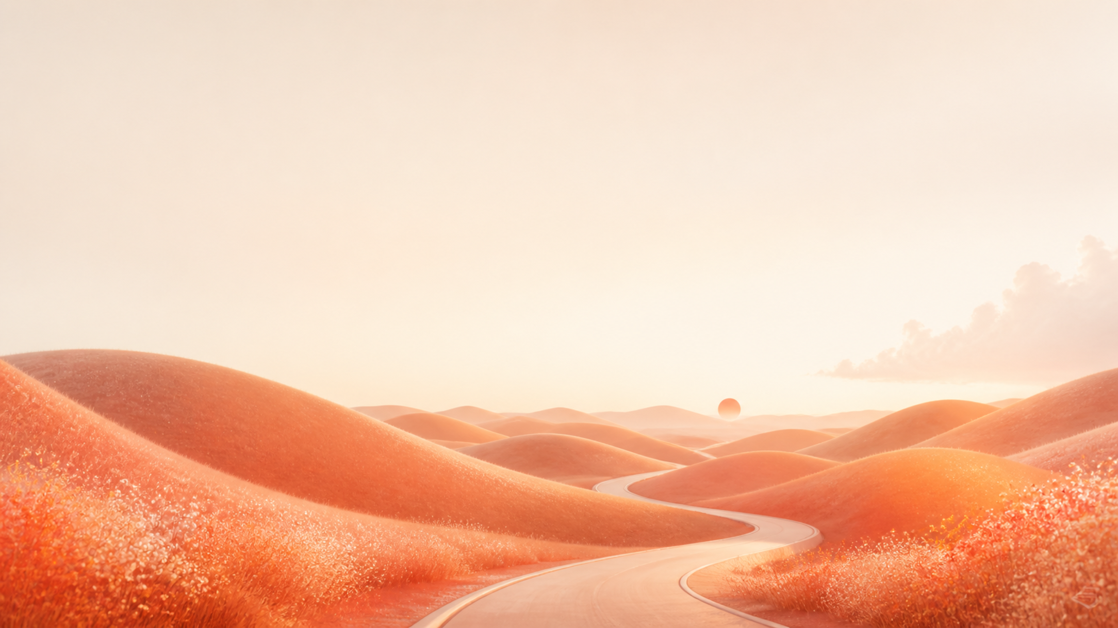 A winding pale road through sunlit coral-colored dunes beneath a soft peach sky